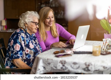 Adult granddaughter teaching her elderly grandmother to use laptop
 - Powered by Shutterstock