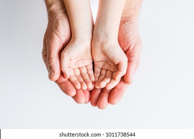 Adult hands holding kid hands, Family Help Care Concept, small hands in fathers  hand.