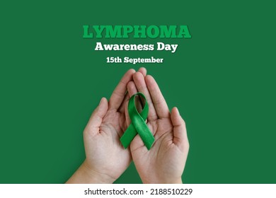 Adult hands holds green ribbon on green background. World lymphoma awareness day. September 15. Cancer and Lymphoma Awareness month - Shutterstock ID 2188510229