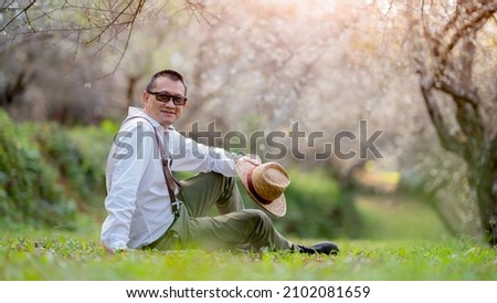 Similar – young man with hat in front of mountain panorama