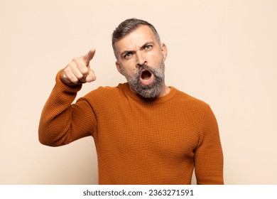 adult handsome man pointing at camera with an angry aggressive expression looking like a furious, crazy boss - Shutterstock ID 2363271591
