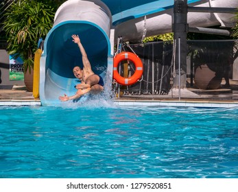 Adult Having Fun On A Waterslide