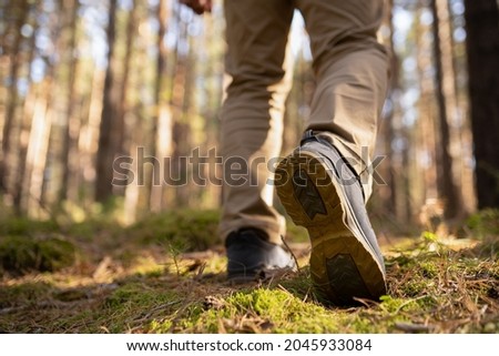adult hiker person walking in the woods. Speed-hiking shoes closeup.