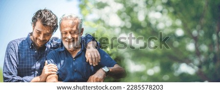 Adult hipster son fun hugging old senior father at home, two generations have a beard talking together and relaxing with smile, 2 man happy enjoy to living at home in father's day with love of family