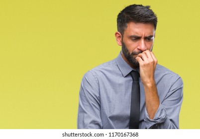 Adult hispanic business man over isolated background looking stressed and nervous with hands on mouth biting nails. Anxiety problem. - Shutterstock ID 1170167368