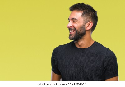 Adult Hispanic Man Over Isolated Background Looking Away To Side With Smile On Face, Natural Expression. Laughing Confident.