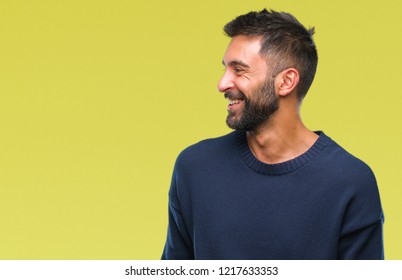 Adult Hispanic Man Over Isolated Background Looking Away To Side With Smile On Face, Natural Expression. Laughing Confident.