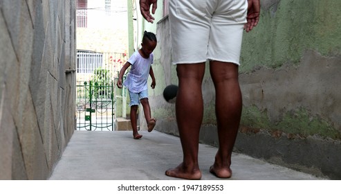 Adult Kicking Ball To Child, Parent And Child Bonding Playing Soccer