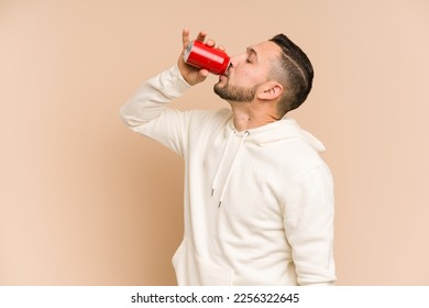 Adult latin man drinking cola refreshment isolated - Powered by Shutterstock