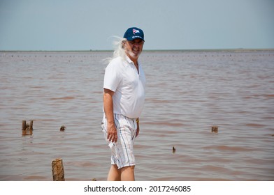 Adult Male Cuban. Old Cuban Man In Cap In Havana. Senior Grizzled Man With Long Gray Hair. Sos Cuba.