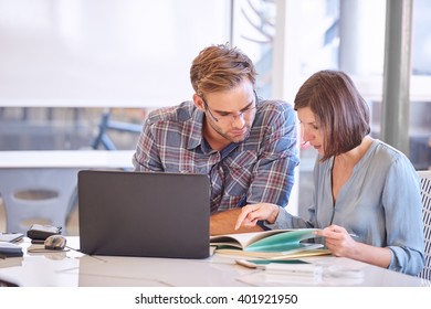 Adult Male And Female Business Partners Busy Working In Office