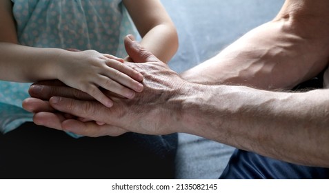 adult male hands holding kid hands, Family Help Care Concept, small hands in fathers hand, touching moment, touch of child and old man, grandfather, parents and child, adopted children, adoption