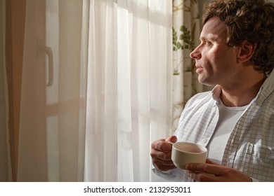 Adult male having teatime in the morning before work - Shutterstock ID 2132953011