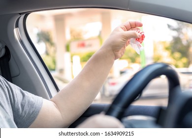 Adult Male Person Throwing Out Paper Fast Food Snack Wrap Garbage In Window Driving Car On Sunny Day. Man Hand Tossing Waste Outside Vehicle. Irresponsible Bad Manner Behaviour Norms. Nature Pollution