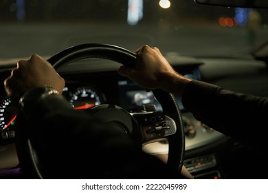 The Adult Man Driving Car At The Night