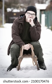 Adult Man Enjoying Winter With Classic Retro Wooden Toboggan