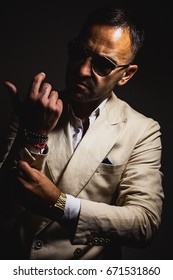 Adult Man Gets Dressed, Wearing Sunglasses, Interesting Bracelets And Old Digital Watch. 