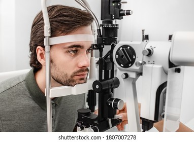 Adult Man Getting An Eye Exam At Ophthalmology Clinic. Checking Retina Of A Male Eye Close-up