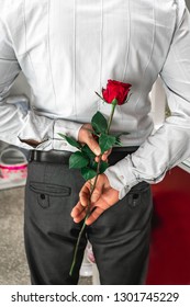 Adult Man Holding Rose Behind His Back, Hiding It As A Gift For His Wife. Romantic Concept