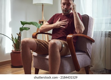 Adult man with knee pain, dislocation, numbness, cramp and other joint issues at home. - Shutterstock ID 2184431529