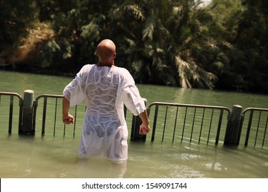 An Adult Man Prays On The Jordan River. Epiphany. Appeal To God. Prayer. Religious Rite Sacrament Of Baptism. Yardenit Israel River Jordan. 