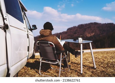 Adult man reading book while travelling with camper van. Concept of modern people lifestyle in smart working or digital nomad freedom. Filtered image. - Shutterstock ID 2138622761