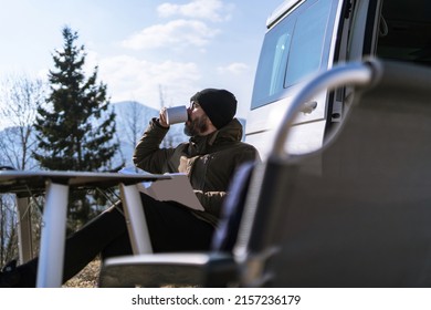 Adult man relaxing drinking a coffee while travelling with camper van. Concept of modern people lifestyle in smart working or digital nomad freedom. Filtered image. - Powered by Shutterstock