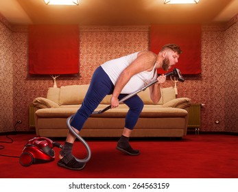 Adult Man Sings To The Vacuum Cleaner At Home Interior