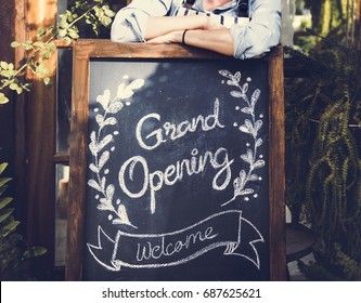 Adult Man Standing With Grand Opening Sign