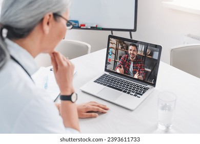 Adult man talking to woman doctor using video conference on laptop gadget. Doctor and patient online, telemedicine concept. Remote consultation with family doctor - Powered by Shutterstock