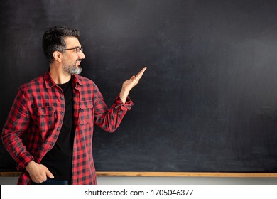 Adult Man Teacher Pointing Empty Blackboard.