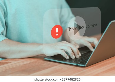 Adult man using a laptop to play social media but this video is blocked or privacy settings have been set. Searching for more internet, and search engine optimization. Subscribing and following.