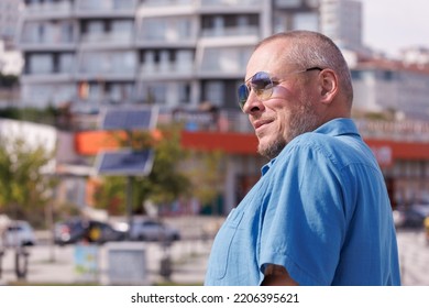 Adult Man Walking In The City On A Sunny Summer Day