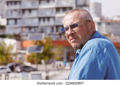 Adult Man Walking In The City On A Sunny Summer Day