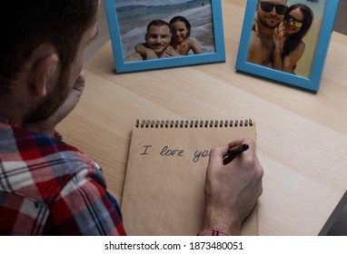 Adult Man Writing A Letter To A Woman And Looking At Photos Of The Happy Traveling Couple, A Holiday Romance.