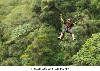 Adult Man Zip Line Adventure In Ecuadorian Rainforest