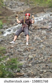 Adult Man Zip Line Adventure In Ecuadorian Rainforest