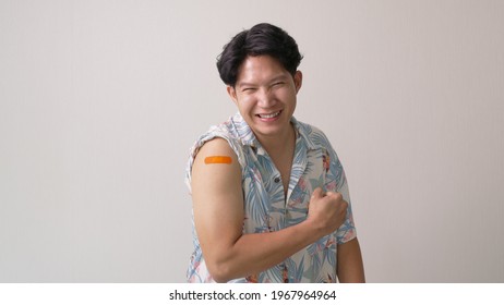 Adult mature attractive handsome asia hipster male after shot receive covid-19 anti virus vaccine in campaign vaccination safe life happy smile cheerful with bandage on arm with copy space. - Powered by Shutterstock