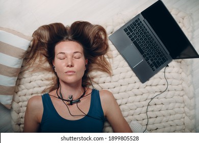 Adult Mature Woman Doing Yoga Nidra And Lay At Home With Online Tutorials On Laptop