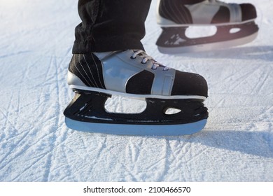 Adult Men's Ice Skates Close-up On Ice In Winter Outdoor On The Move. Rolling And Sliding In Frosty Sunny Day, Active Winter Sports And Lifestyle