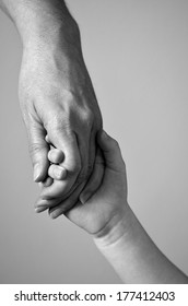 Adult Or Parent Holding The Hand Of A Small Child