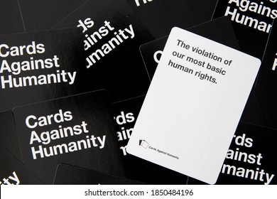 Adult Party Game Cards Against Humanity Scattered White And Black Cards Referencing Human Rights