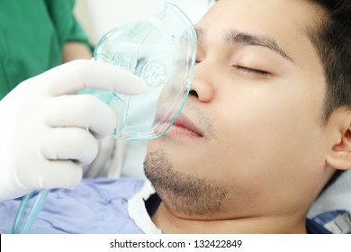 Adult Patient Receiving Oxygen Treatment From A Health Worker.