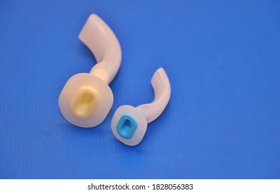 Adult And Pediatric Oral Airways Used During Intubation And Anesthesia .Image Isolated On A Blue Background 