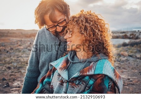 Adult people enjoy love and relationship outdoor. Man and woman have leisure activity with ocean and sky in background.  Romance lifestyle for young mature couple