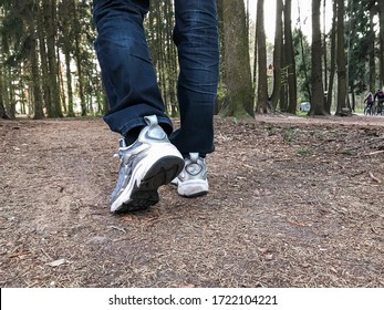 Adult person running in the forest alone in isolation during pandemic quarantine mode,man walking down the street in the forest on distance