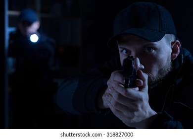 Adult Police Officer Pointing Gun At Criminal