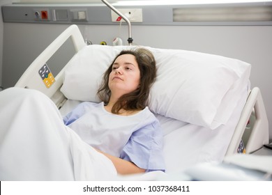 Adult Sad Woman Is Lying Fever On The Bed In Hospital Indoor