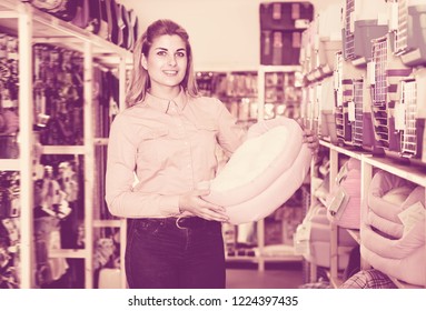 Adult Saleswoman Offering Pet Bed In Pet Store