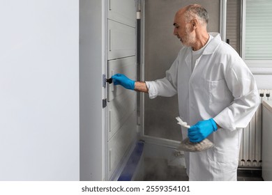 An adult scientist in a white coat and blue gloves manipulates a cryogenic freezer in a modern laboratory.  - Powered by Shutterstock